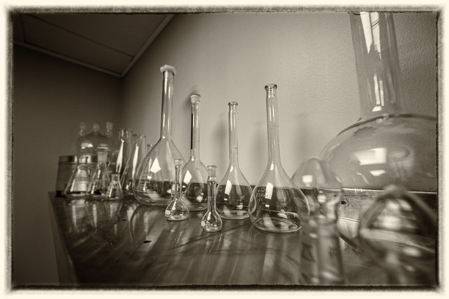 A glass of beer on a bar.